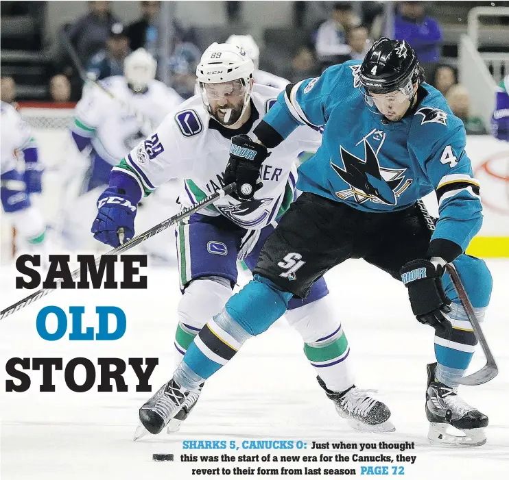  ?? — THE ASSOCIATED PRESS ?? San Jose’s Brenden Dillon and Vancouver’s Sam Gagner battle for the puck during the first period of the Sharks-Canucks game Saturday night in San Jose.