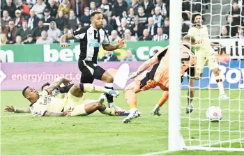  ?? — AFP photo ?? Newcastle United’s striker Callum Wilson watches as the ball goes in off of Arsenal’s English defender Ben White to score the opening goal during the English Premier League match at St James’ Park in Newcastle-upon-Tyne, north east England.