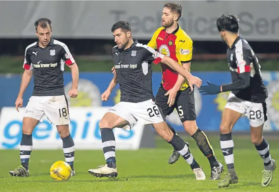  ??  ?? Dundee’s Kostadin Gadzhalov holds off Danny Devine. The big defender was adjudged to have committed the foul which led to Thistle’s first goal.