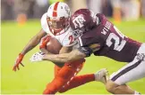  ?? SAM CRAFT/ASSOCIATED PRESS ?? New Mexico wide receiver Jay Griffin IV is tackled by Texas A&M’s Priest Willis on Saturday night. UNM passed for just 24 yards in the game.