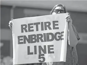  ?? ASSOCIATED PRESS CORY MORSE/THE GRAND RAPIDS PRESS VIA ?? In this Thursday, July 6, 2017, file photo, Lauren Sargent, of Ann Arbor, Michigan, takes part in a protest before the Enbridge Line 5 pipeline public informatio­n session at Holt High School in Holt, Michigan.