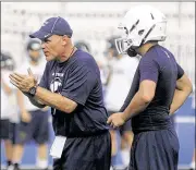  ?? MARC PENDLETON / STAFF ?? New Fairmont coach Dave Miller (left) cheers on his players during a passing camp Thursday. Miller was hired after a successful run at Covington.