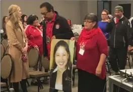  ?? STEVE LAMBERT, THE CANADIAN PRESS ?? Bernice Catcheway, right, carries a picture of her daughter, Jennifer Catcheway, into the hearing.