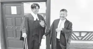  ?? ?? PEGUAM DEFENDAN: Yong (kiri) dan Tan keluar dari kamar mahkamah selesai prosiding kes.