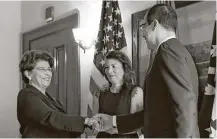  ?? Carolyn Kaster / Associated Press ?? Treasury Secretary Steven Mnuchin congratula­tes new Treasurer Jovita Carranza. In the center is Carranza’s daughter, Klaudene Carranza.