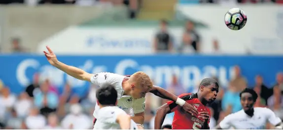  ??  ?? Jay Fulton heads home the winning goal for Swansea yesterday