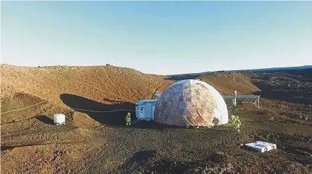  ?? — AP ?? Far from civilizati­on: Crew members performing tasks around the Hawaii Space Exploratio­n Analog and Simulation dome on Mauna Loa volcano.