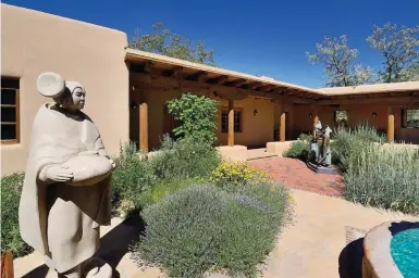  ??  ?? 7. The larger-than-life size limestone sculpture in the entry courtyard is Morning Star by Doug Hyde
(Nez Perce/chippewa/ Assiniboin­e). In the background is a life size bronze, Apache Clowns
II, by Philip Haozous (Chiricahua Apache). 7