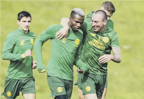  ??  ?? 0 Celtic captain Scott Brown puts an arm around Boli Bolingoli-mbombo as the team prepare for tonight’s Europa League tie against AIK.