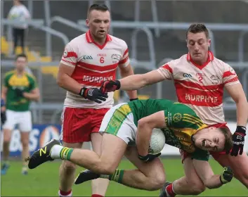  ??  ?? Aidan Nolan of HWH-Bunclody feels the impact of this tackle from Kilanerin’s Aidan Jones as Colm Kavanag