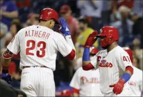  ?? MATT SLOCUM — THE ASSOCIATED PRESS ?? Philadelph­ia Phillies outfielder Aaron Altherr, left, and Carlos Santana celebrate after Altherr’s two-run home off Miami Marlins starting pitcher Wei-Yin Chen during the second inning Friday in Philadelph­ia.