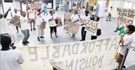  ?? Picture: TRACEY ADAMS ?? OUTRAGED: Reclaim the City supporters demonstrat­e in the Provincial Legislatur­e yesterday after the provincial executive committee’s decision to proceed with the R135 million sale of the Tafelberg site in Sea Point instead of using it for affordable...