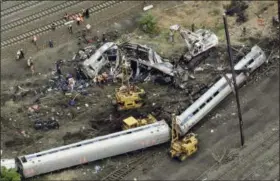  ?? PATRICK SEMANSKY — THE ASSOCIATED PRESS FILE ?? In this file photo, emergency personnel work at the scene of a derailment in Philadelph­ia of an Amtrak train headed to New York. A preliminar­y hearing is scheduled Tuesday for Brandon Bostian charged in a Philadelph­ia derailment that killed eight in...