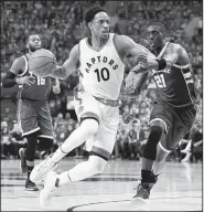  ?? AP/The Canadian Press/NATHAN DENETTE ?? Milwaukee Bucks guard Tony Snell (right) gives chase as Toronto Raptors guard DeMar DeRozan drives to the basket Tuesday in Toronto.