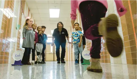  ?? BILL TIERNAN/FREELANCE PHOTOS ?? Kindergart­en teacher Janet Viney works with students in the hallway of Alfred S. Forrest Elementary in Hampton. After reading a book about kindness, Viney took the students into the hallway, where they had to decide if a statement she read was kind or unkind. It was part of the Elementary Arts and Literacy Program in Hampton Public Schools.