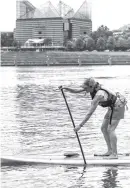  ??  ?? Below: Leigh Linhoss paddles on the Tennessee River.