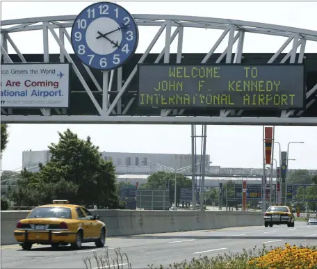  ?? AP PHOTO/STUART RAMSON, FILE ?? A clock at the entrance to JFK Airport in New York is pictured on Aug. 15, 2003.