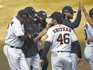  ?? KEVORK DJANSEZIAN/GETTY-AFP PHOTOS ?? Manager Dusty Baker, left, celebrates with Astros players and coaches after eliminatin­g the A’s on Thursday.