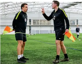  ?? GETTY IMAGES ?? How hard is it? Neville and Carragher try out refereeing