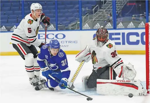  ?? CHRIS O’MEARA/AP ?? Hawks goalie Malcolm Subban makes a save Wednesday against the Lightning’s Yanni Gourde. The teams played again Friday.