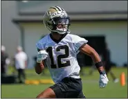  ?? Associated Press ?? Working out: New Orleans Saints wide receiver Chris Olave (12) works out during the NFL football team's rookie minicamp Saturday in Metairie, La.