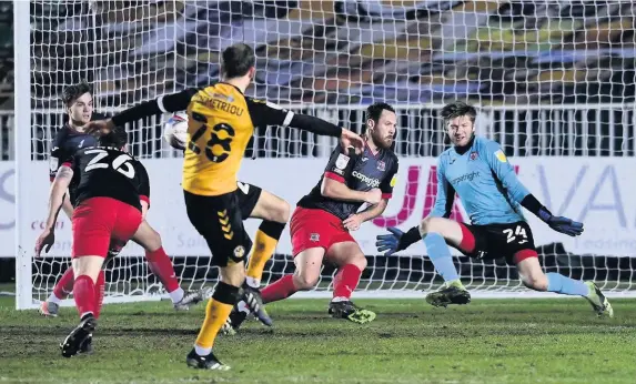  ?? Phil Mingo/PPAUK ?? > Tom Parkes of Exeter City puts his body on the line to block a shot from Newport’s Mickey Demetriou in the 1-1 draw at Rodney Parade