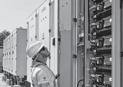  ?? REUTERS ?? Arlo Brownlee, an engineer, surveys battery banks at Glidepath’s Byrd Ranch energy storage facility in Sweeny, Texas, May 23.