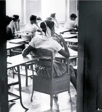 ??  ?? 1. An unidentifi­ed black student is shown, above, in this Aug. 31, 1956, photo sitting inside a classroom at the newly integrated Clinton High School in Clinton, Tenn. She sits in a rear seat, separated by empty desks from her white classmates. 1