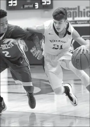  ?? Arkansas Democrat- Gazette/ STEPHEN B. THORNTON ?? Gavin Stone ( right) drives to the basket against defender DaMecko Johnson on Tuesday during Riverside’s 63- 54 victory over KIPP Delta at the Class 3A boys state tournament in Bald Knob. Stone fi nished with 28 points for the Rebels.