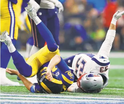  ?? CURTIS COMPTON/TNS ?? Los Angeles Rams quarterbac­k Jared Goff, 16, is leveled on a pass attempt in the fourth quarter, leading to an incomplete pass, against the New England Patriots Sunday night in Atlanta.