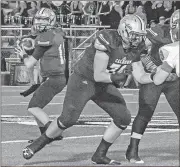  ??  ?? Tim Godbee, for the Calhoun TimesCalho­un quarterbac­k Gavin Gray (left) drops back behind his offensive line before throwing a pass in the first quarter.