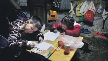  ?? Photograph­s by Robyn Dixon Los Angeles Times ?? STUDENTS at Baiyan Hope school do their homework after classes. The village school was founded in the 1990s and is staffed by volunteers. Still, studies show rural students are much less likely to go to college.