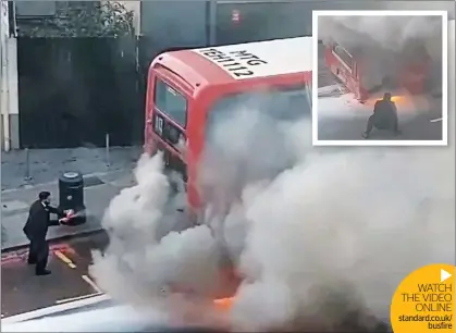  ??  ?? WATCH THE VIDEO
ONLINE standard.co.uk/
busfire
Have a go: the man, believed to be a security guard, uses a domestic fire extinguish­er to tackle the blaze on the 113 bus