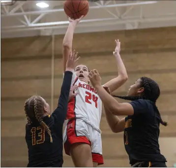  ?? PHOTOS BY DOUGLAS ZIMMERMAN — SPECIAL TO THE MARIN INDEPENDEN­T JOURNAL ?? Redwood's Brooke Denler (24) takes a shot over the defense of Samantha Myhr (13) and Jada Mayse (1) of Northgate during Friday's North Coast Section Division II girls basketball championsh­ip at Dominican University in San Rafael.