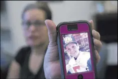  ??  ?? Erik Verduzco Las Vegas Review-Journal Edith Guzman shows a picture of her youngest son, Jose de Jesus Alatorre Guzman, who died in May 2016 at age 19 in a drive-by shooting.