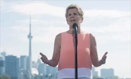  ?? MARTA IWANEK
THE CANADIAN PRESS ?? Ontario Liberal Leader Kathleen Wynne speaks to reporters at Ontario Place in Toronto on Friday.