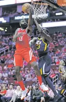  ?? MICHAEL WYKE/THE ASSOCIATED PRESS ?? Rockets guard James Harden lays up a shot past Jazz center Ekpe Udoh on Sunday in Houston. Harden scored a career-high 56 points to lead Houston to a 137-110 win.