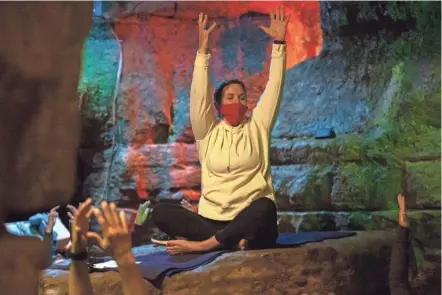  ?? NICOLAS GALINDO PHOTOS/THE COLUMBUS DISPATCH ?? Instructor Kelly Heiss leads a yoga session at Olentangy Indian Caverns in Delaware County. “This is just one of those special, unique experience­s,” she said.