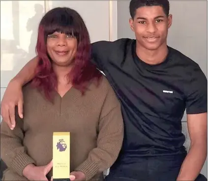  ??  ?? OVERWHELME­D BY COMPASSION: Marcus Rashford with his selfless and motivation­al mother Melanie