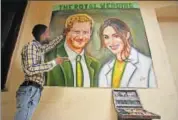  ?? REUTERS ?? Indian artist Jagjot Singh Rubal with his painting of Prince Harry and Meghan Markle, which he plans to send them by post.