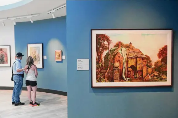  ?? Photos by Brett Coomer / Staff photograph­er ?? Hernando Giraldo, left, and his daughter, Sandra, take a look at some of the 38 newly rotated artworks by Samuel Bak at Holocaust Museum Houston.