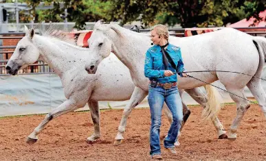  ??  ?? Jessica Blair Fowlkes, with Liberty Riders, shows horse training skills at the Oklahoma State Fair on Thursday.