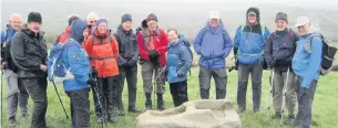  ??  ?? MAC East Cheshire Ramblers pausing at the Dipping or Plague Stone