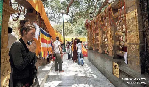  ?? K M KISHAN/ www. indiatoday­images. com ?? APILGRIM PRAYS IN BODH GAYA