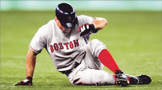  ?? RICK MADONIK/TORONTO STAR ?? Red Sox outfielder Gabe Kapler writhes in pain after rupturing his Achilles tendon while rounding second base on a homer by Tony Graffanino in the fifth inning last night.