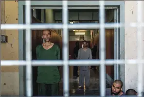  ?? ?? Drug addicts undergoing treatment stand in the detoxifica­tion ward of a drug treatment camp June 19 in Kabul.