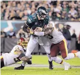  ?? MATT ROURKE/ASSOCIATED PRESS ?? Philadelph­ia quarterbac­k Carson Wentz (11) is hit by Washington’s Mason Foster (54) and Zach Brown during the Eagles’ win Monday.