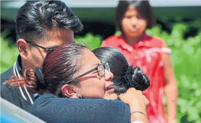  ?? PEDRO PARDO/AFP/GETTY IMAGES ?? Women embrace at the site of a series of explosions at fireworks warehouses in Tultepec, central Mexico.