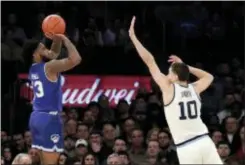  ?? JULIO CORTEZ — THE ASSOCIATED PRESS ?? Seton Hall’s Myles Powell (13), of Trenton Catholic, shoots against Villanova’s Cole Swider (10) during the first half in the championsh­ip of the Big East Conference tournament on Saturday in New York. The Associated Press