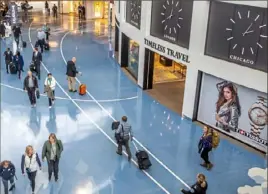  ?? Alexandra Wimley/Post-Gazette ?? Travelers walk through the Airmall in the Pittsburgh Internatio­nal Airport terminal Thursday in Findlay.